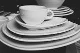 A stack of dinner china demonstrating the types of secondhand fine china available at online thrift store BinxBerry Consignment