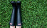 Black Hunter knee-high boots showcasing the luxury brands collection at our online thrift store.