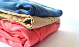 A stack of women's secondhand pants from online consignment store BinxBerryConsignment.com
