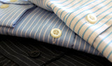 A stack of button up shirts from online consignment store BinxBerryConsignment.com