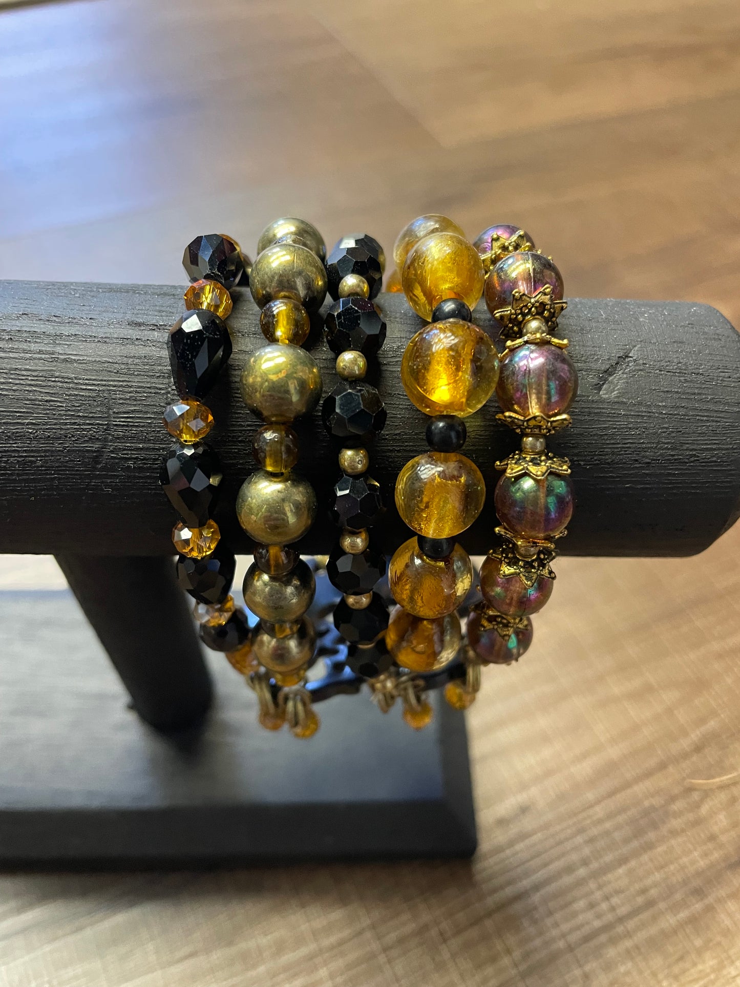 Gold & Black Beaded Bracelet with Black Emblem