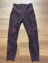 Purple leggings with a subtle pattern on a wooden floor

