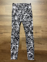 Black and white patterned leggings on a wooden floor

