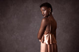 A woman in a silk dress, like the 100% natural silk apparel available at online consignment shop BinxBerry.